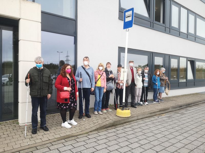 Blind and partially sighted participants waiting for their autonomous bus during a test in Luxembourg