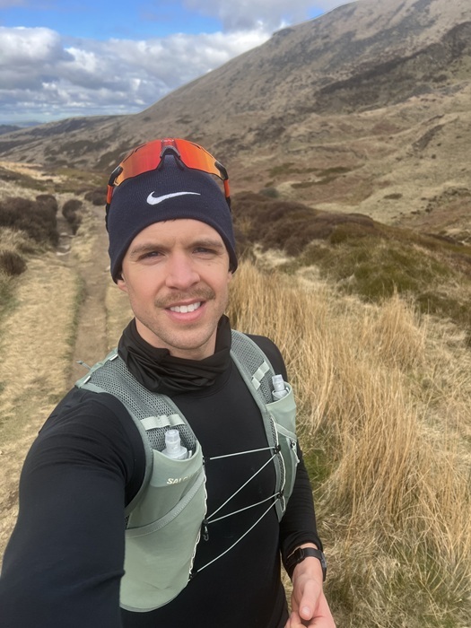 A selfie of James running in the countryside