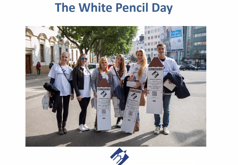 6 young people in the street wearing white pencil day t-shirts and carrying banners.